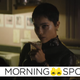 Zoe Kravitz's Selina Kyle holds up a drink in a scene from The Batman
